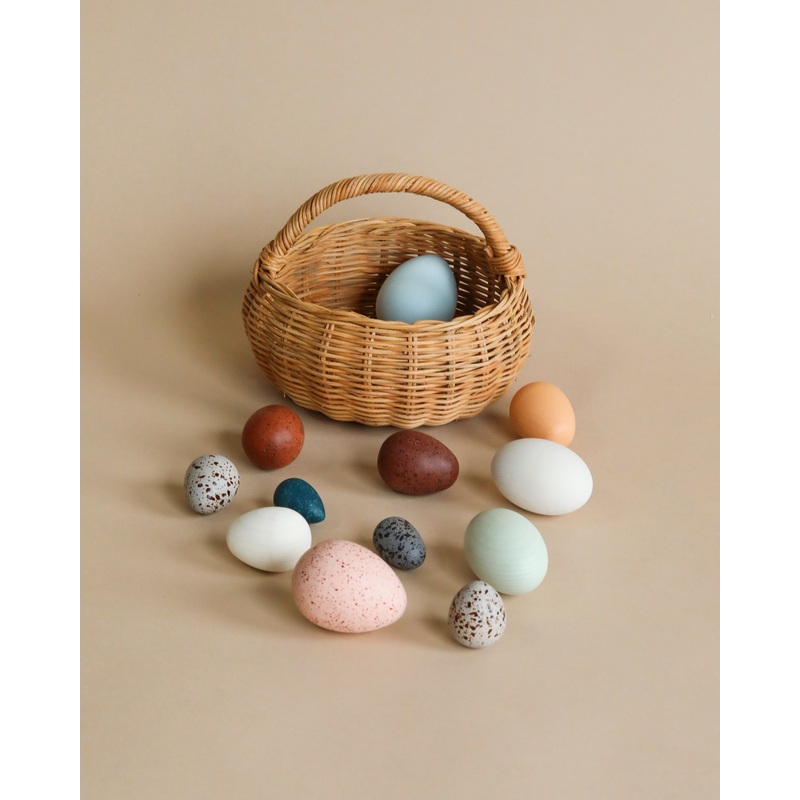 A Dozen Wooden Bird Eggs In A Basket
